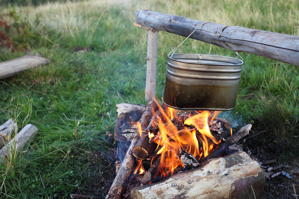 camp fire and preparing food in kettle - Photo, Image