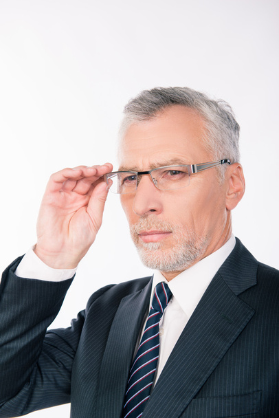 Handsome intelligent old man in business suit holding glasses - Foto, Bild