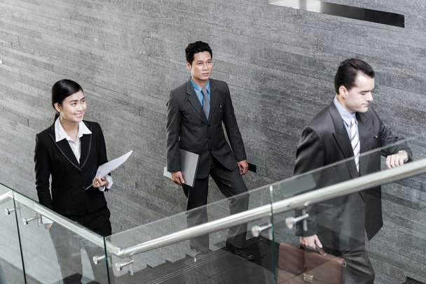 Asian business people walking up stairs - Photo, Image