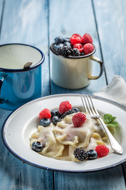 Homemade dumplings with berry fruits and cream - 写真・画像