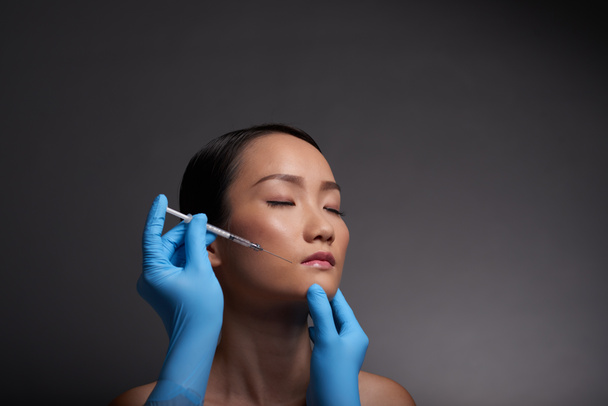 Face of woman getting injection - Photo, Image