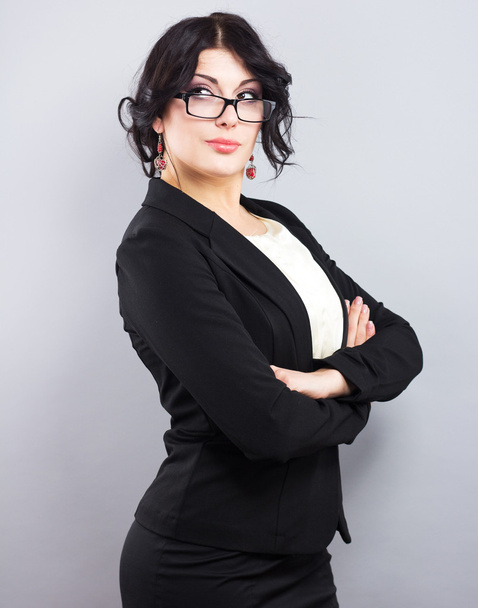 Business woman in a narrow black jacket. Successful woman. Beautiful brunette. Portrait of a beautiful girl in glasses - Photo, image