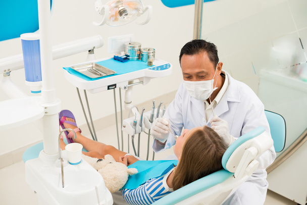 Doctor examining teeth of girl - Photo, Image