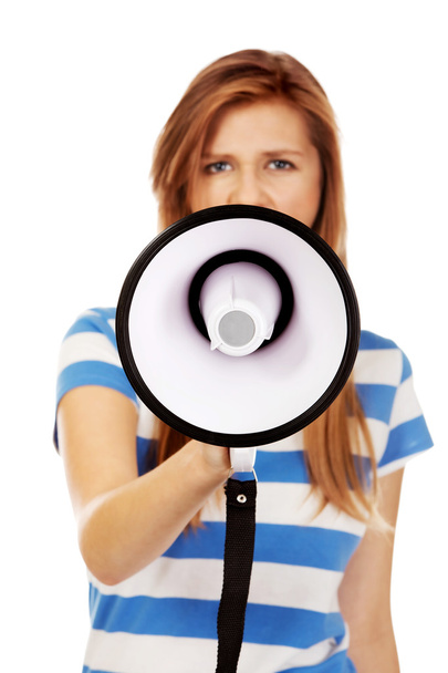 Teenage woman screaming through megaphone - Фото, изображение