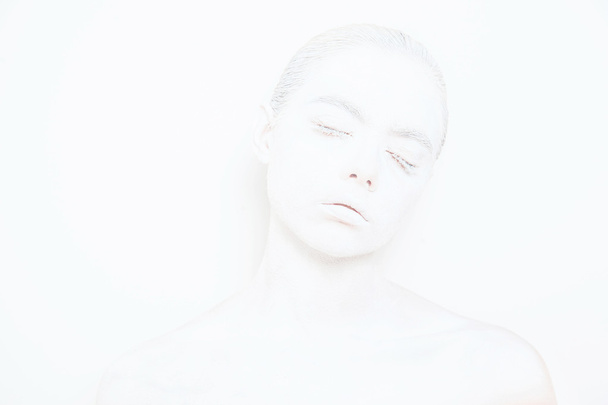 Girl with White Paint on the Skin on a White Background - Φωτογραφία, εικόνα