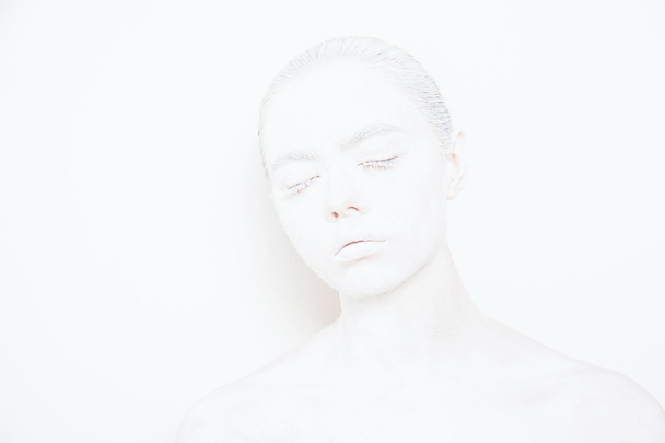 Girl with White Paint on the Skin on a White Background - Foto, Imagem