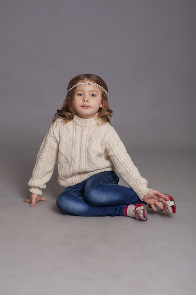 Little girl in white sweater and jeans - Valokuva, kuva