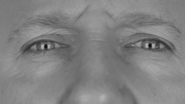 Close-up in black and white on  mans eyes, angry eye - Felvétel, videó