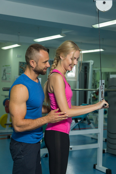 Young couple in the gym at the joint training - Photo, Image