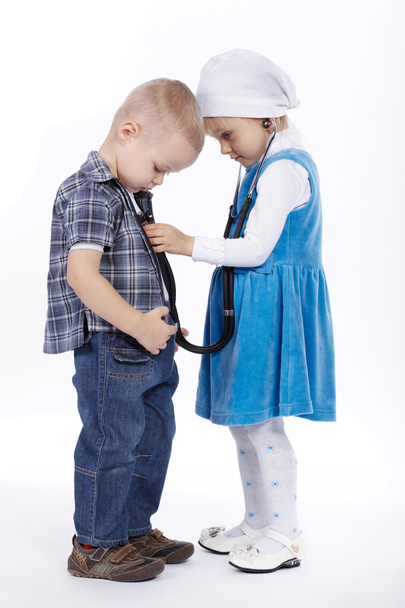 little girl and boy playing with stethoscope - Fotografie, Obrázek