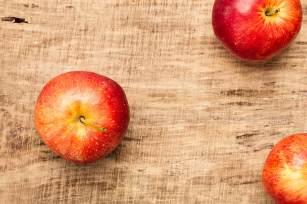 Red apples with wooden background - 写真・画像