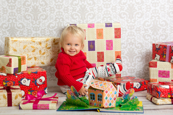 Happy girl among the christmas presents - Фото, изображение