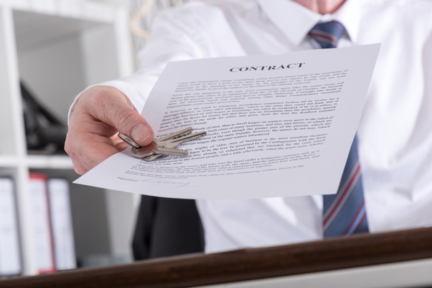 Real estate agent giving keys with contract - Photo, Image