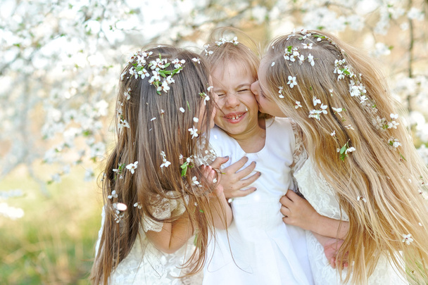 Portrait of little girls sisters in spring - 写真・画像