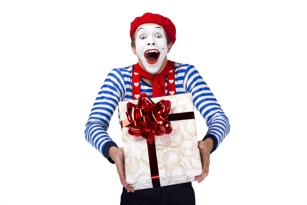Mime with present.Emotional funny actor wearing sailor suit, red beret posing on white isolated background. - 写真・画像