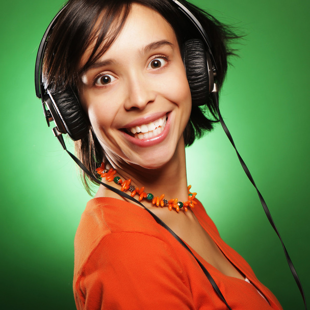 Young  woman with headphones listening music - Foto, afbeelding