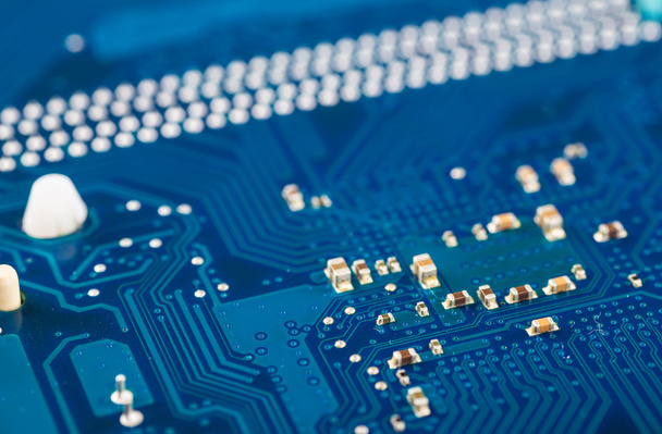 close-up of electronic circuit board with processor blue backgro - Foto, imagen