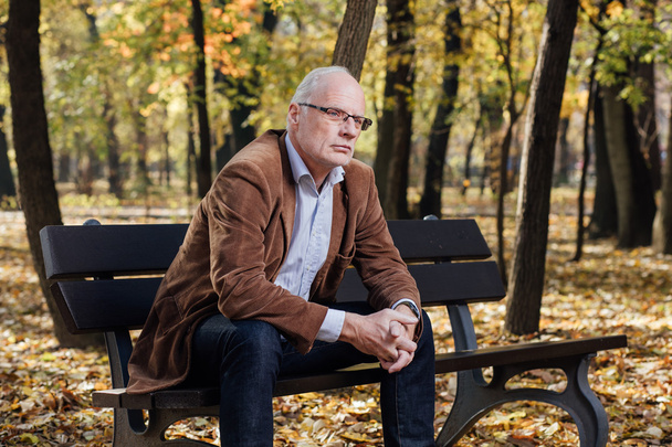 old elegant man sitting on bench outside - Fotografie, Obrázek
