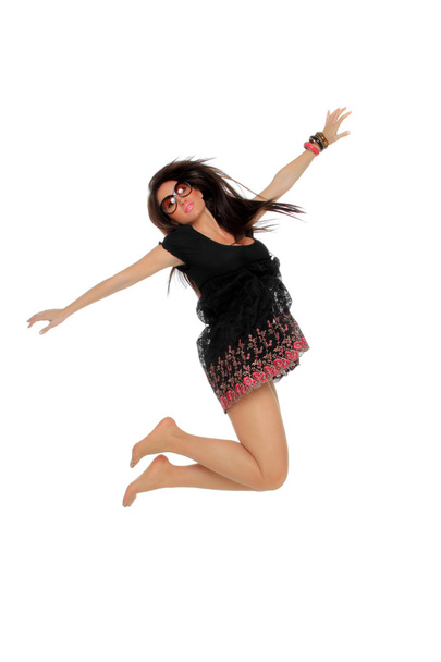 Portrait of a pretty young woman jumping in joy - Foto, Imagen