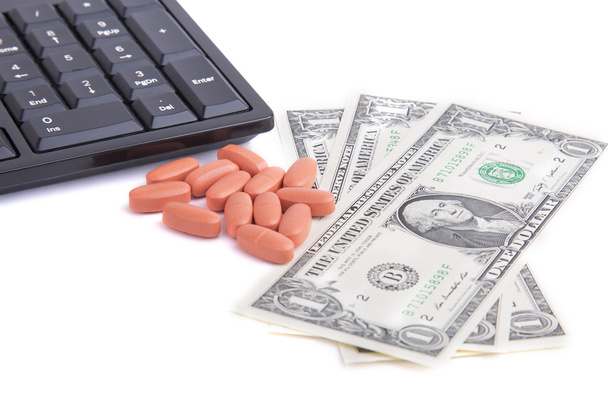 pills, keyboard and US dollars on a white background - Foto, Imagen