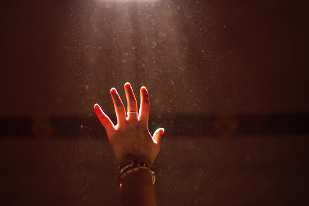 Woman hand into the light - Photo, Image