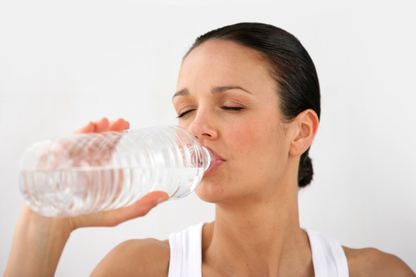 Woman drinking bottled water - Photo, image