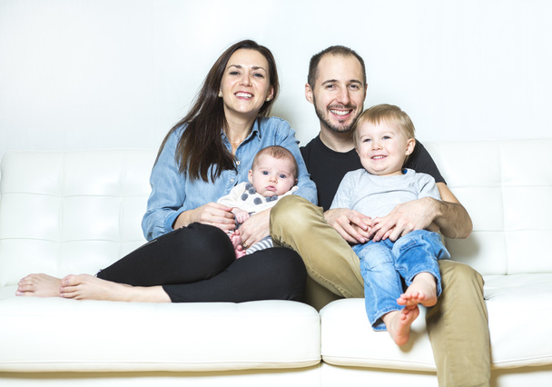 Young happy family with two children at home - Photo, image