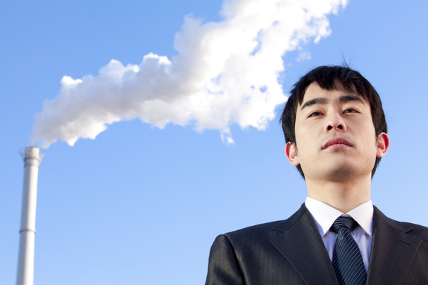 Businessman in Front of Smokestack - Photo, Image
