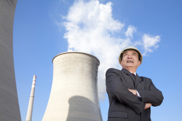 Businessman in front of cooling tower - Photo, Image