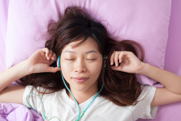 Asian young girl listening  music - Photo, image
