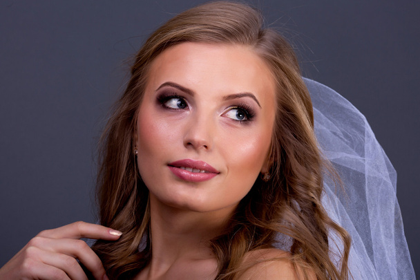 Portrait of beautiful female model on blue background - Foto, afbeelding