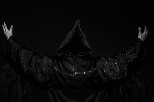 Un actor teatral profesional disfrazado de sacerdote sobre un fondo oscuro
 - Foto, imagen