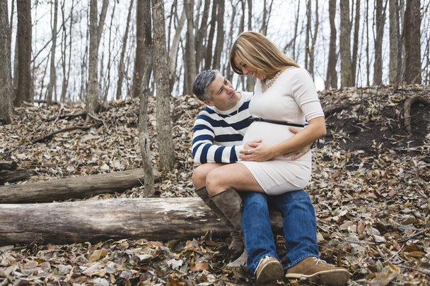 Beautiful outdoor pregnant couple portrait in autumn nature - Foto, Imagen