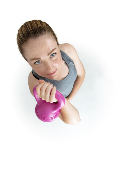 Fitness female exercising crossfit with kettlebell in studio.  - Photo, Image
