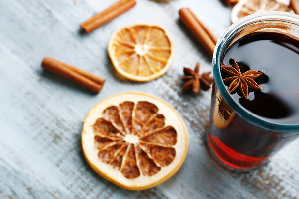 Tasty mulled wine and spices, on blue wooden background, close-up - Zdjęcie, obraz