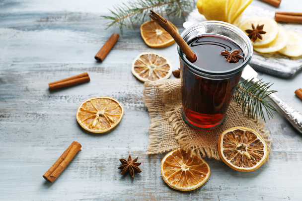 Tasty mulled wine and spices, on blue wooden background, close-up - Фото, зображення