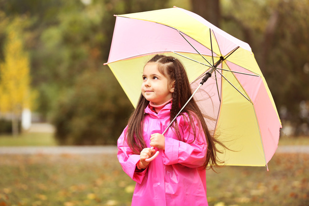Beautiful little girl with umbrella   - Photo, image
