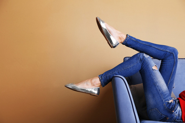 Woman legs on sofa with stylish shoes - Photo, image