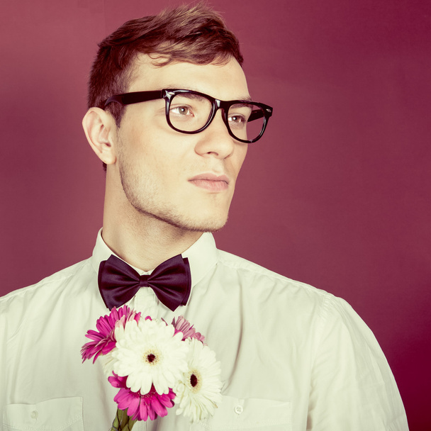 Young beautiful man with flowers - Fotoğraf, Görsel