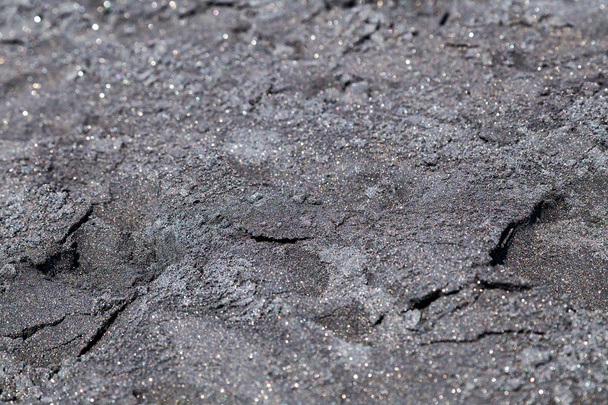 Nahaufnahme von schwarzem vulkanischen Sand - Foto, Bild