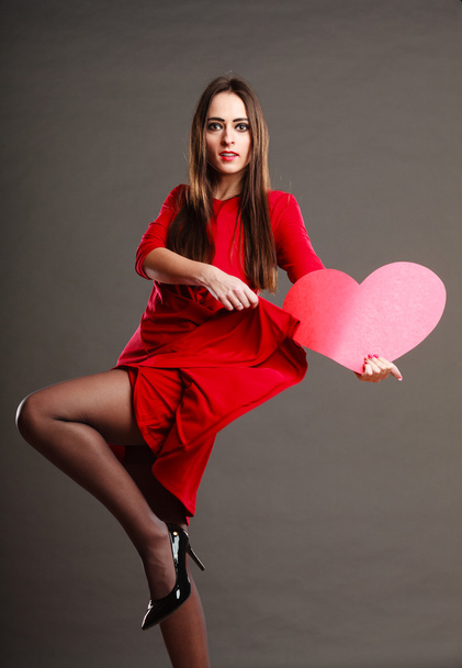 Woman in red dress holds heart sign - Foto, imagen