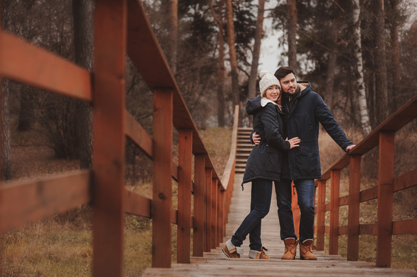 loving young couple happy together outdoor on cozy warm walk in forest - Foto, Imagen