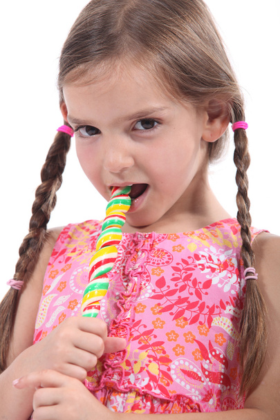 Girl eating a lolly pop - Фото, зображення