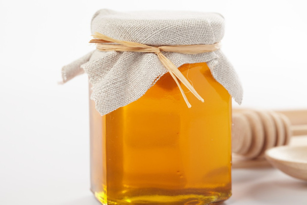 Honey with wood stick - Фото, зображення