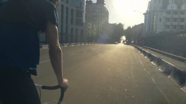 young handsome man riding a bicycle in the city slow motion - Footage, Video