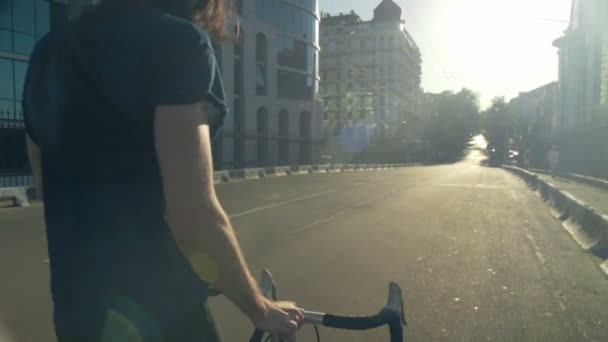 young man going on the road near his bicycle slow motion - Footage, Video