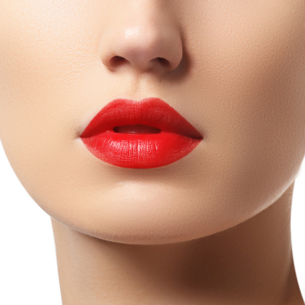 Close-up of woman's lips with bright fashion red glossy makeup. Macro bloody lipgloss make-up - Фото, изображение