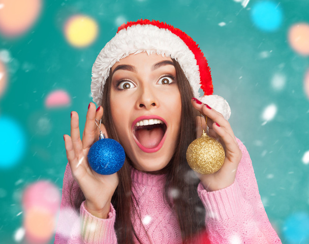 Model in hat with christmas balls - Фото, изображение