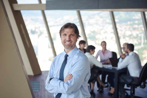 businessman portrait at modern bright office indoors with his team in group working together in background - Photo, Image