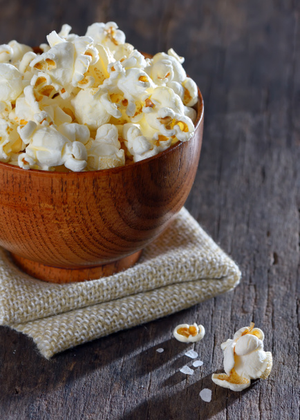 Salty popcorn on wooden table - Photo, Image